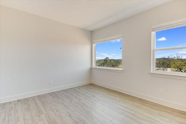 Spare room with baseboards and light wood-style floors | Image 15