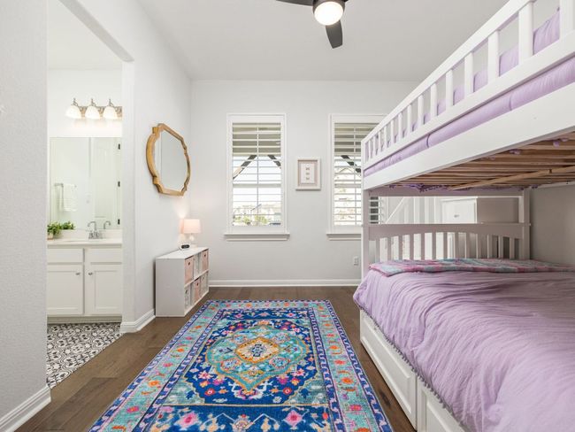 Bedroom featuring a ceiling fan, a sink, ensuite bath, and dark wood-style floors | Image 15