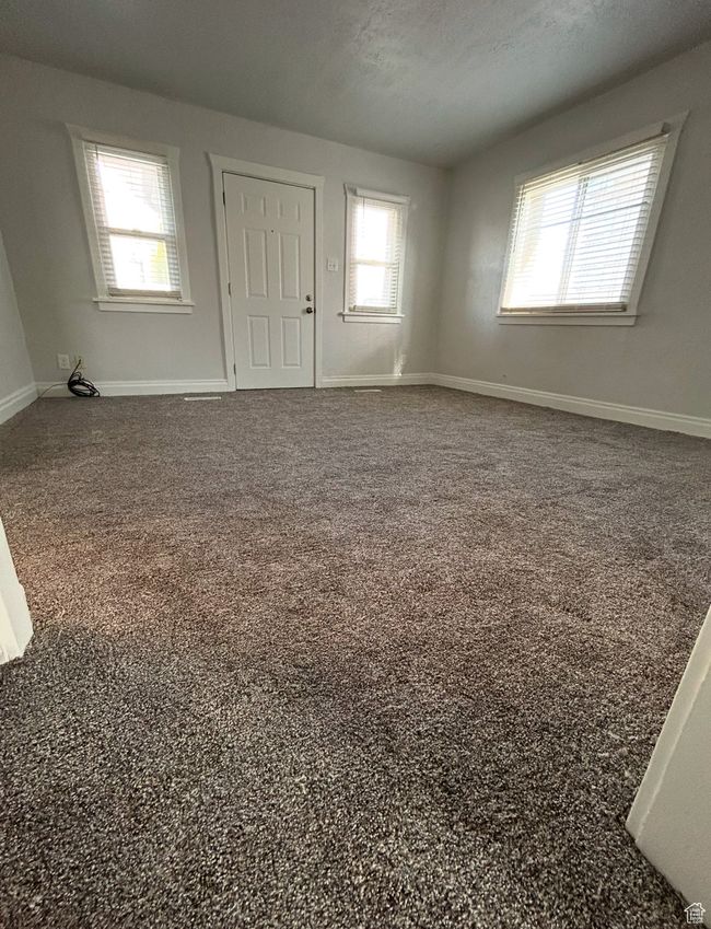 Carpeted spare room featuring baseboards and a textured ceiling | Image 5
