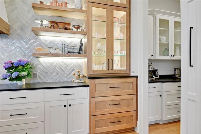 Bar featuring bar, backsplash, and light wood finished floors | Image 22