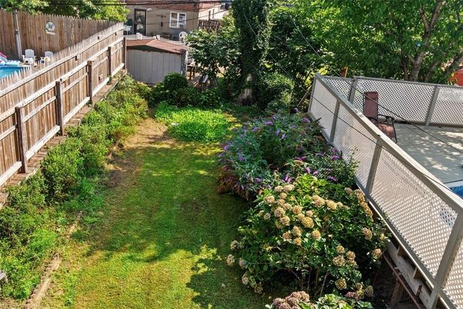 View of yard with a storage unit | Image 16