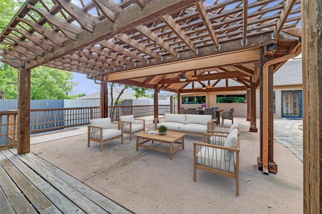 View of patio with outdoor lounge area, a pergola, a wooden deck, and ceiling fan | Image 31