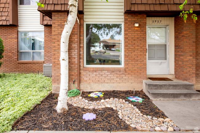 Entrance to property with central AC, mansard roof, and brick siding | Image 15