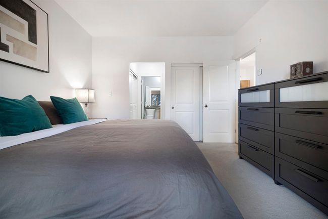 Bedroom with connected bathroom and light carpet | Image 16