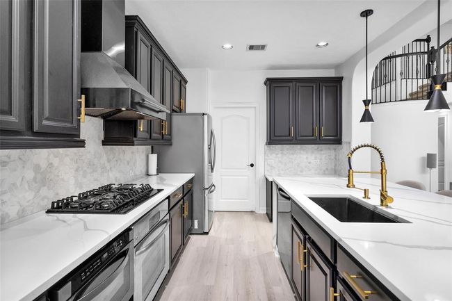 Custom backsplash and stainless steel appliances. | Image 17