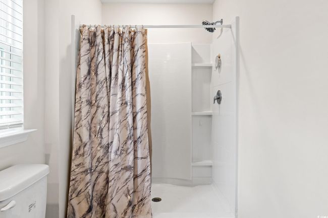 Bathroom featuring toilet and walk in shower | Image 19