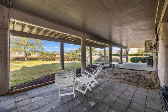 View of patio with grilling area lower level carport area. Additional owner storage room | Image 29