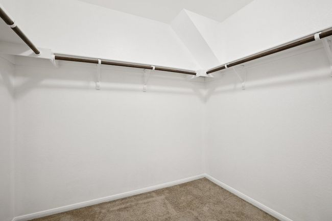Spacious closet with light carpet | Image 23
