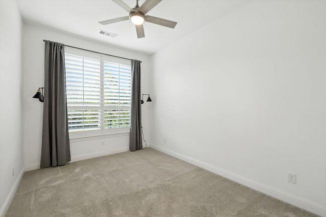 Unfurnished room featuring carpet and a ceiling fan | Image 26