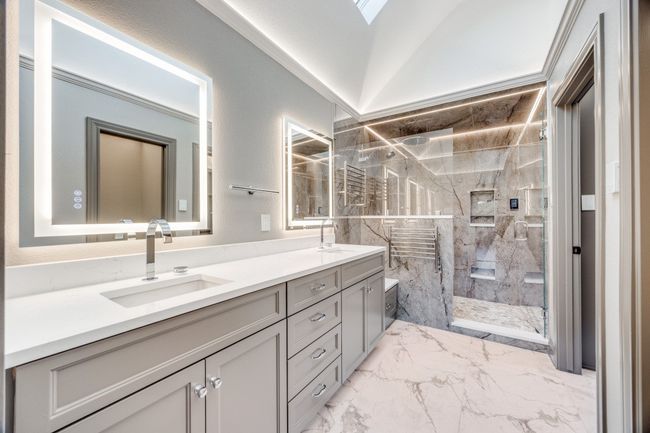 Full bathroom with marble finish flooring, double vanity, and a marble finish shower | Image 14