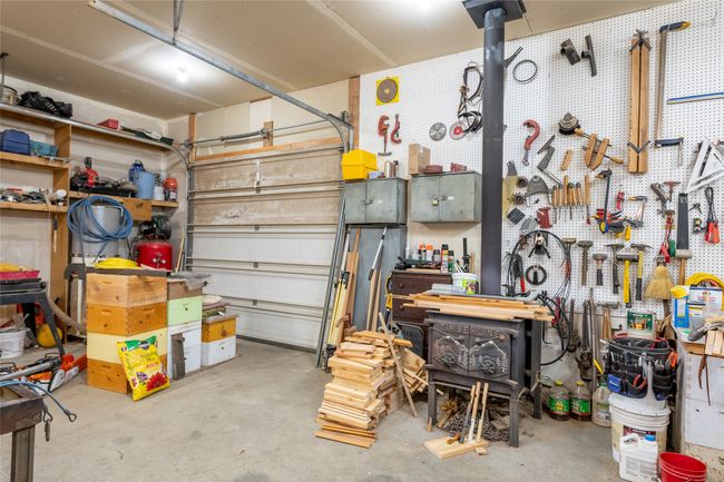 Garage featuring a workshop area | Image 65