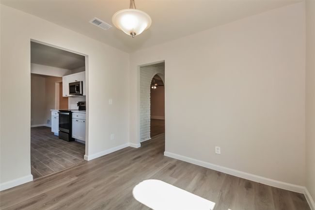 Empty room featuring light wood-style floors and baseboards | Image 9