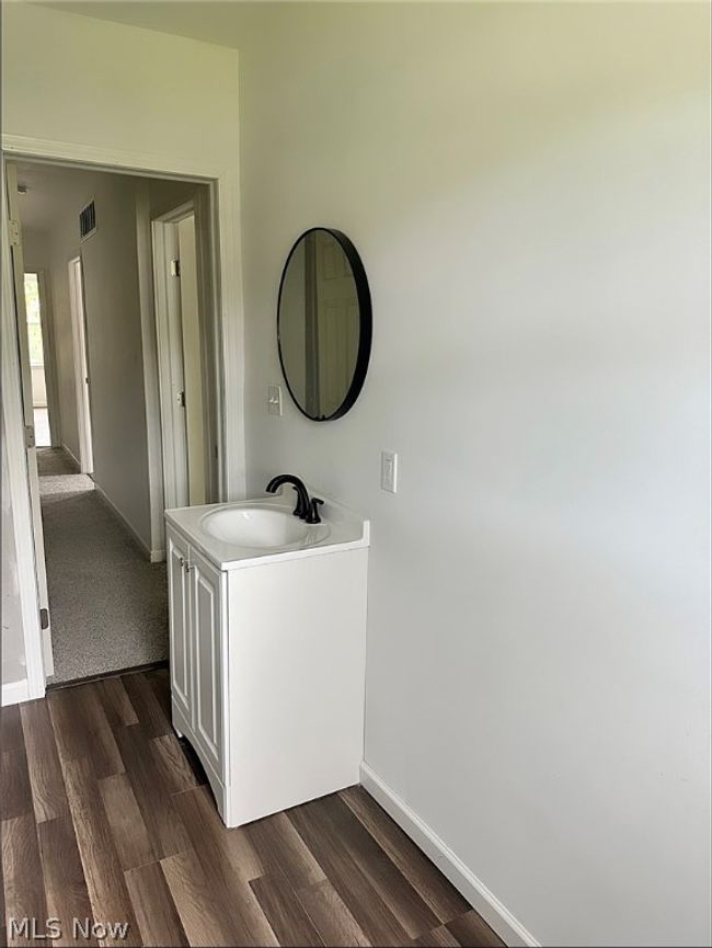 Bathroom featuring hardwood / wood-style flooring and vanity | Image 13