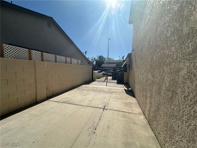 View of concrete surface featuring a gated entry | Image 21