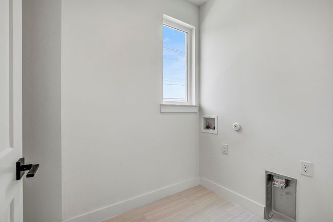 Laundry area with hookup for a washing machine, hookup for a gas dryer, baseboards, light wood finished floors, and electric dryer hookup | Image 22