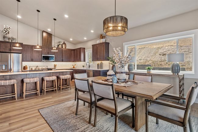 Dining area with light wood-style floors, recessed lighting, and high vaulted ceiling | Image 43