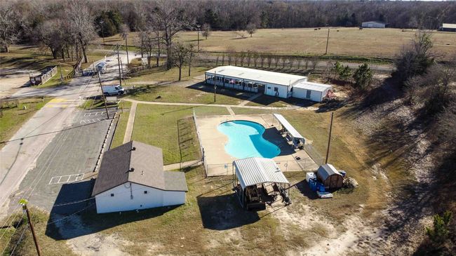 Birds eye view of property with a rural view of pool, restroom facility and more | Image 37