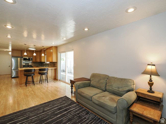 Living room featuring light wood finished floors and recessed lighting | Image 12