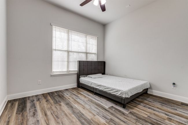 Bedroom featuring ceiling fan, baseboards, and wood finished floors | Image 16