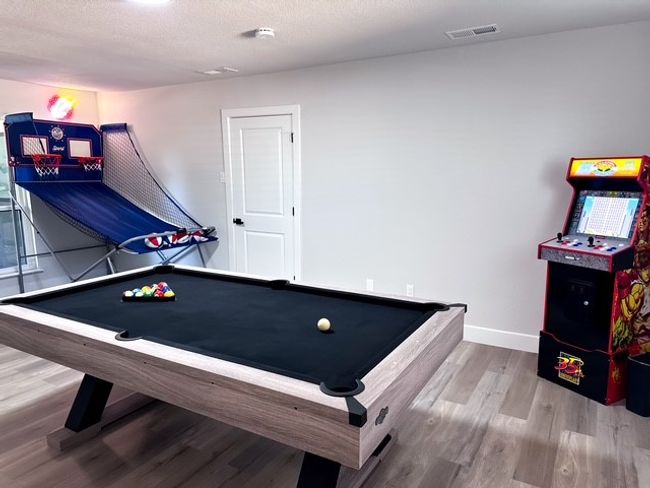 Game room with wood-type flooring and billiards | Image 15
