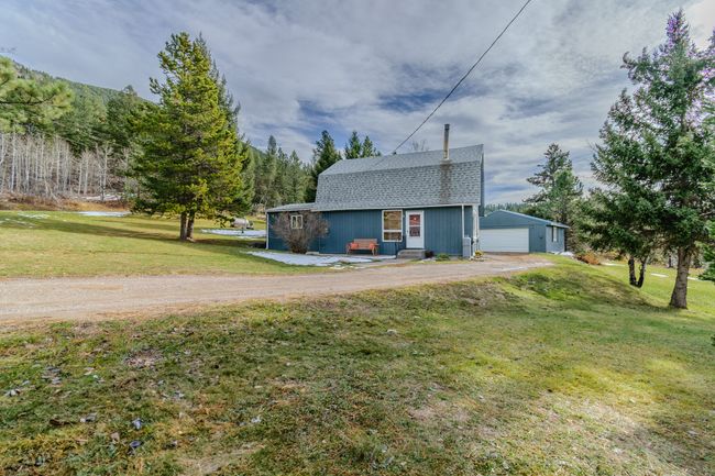 View of front of home with an outbuilding, a garage, and a front lawn | Image 71