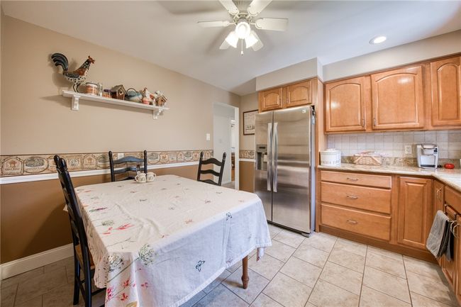 Eat-in-kitchen with maple cabinets, stainless steal appliances, and granite countertops | Image 16