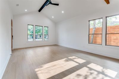 Spare room featuring high vaulted ceiling, light hardwood / wood-style floors, and beam ceiling | Image 3