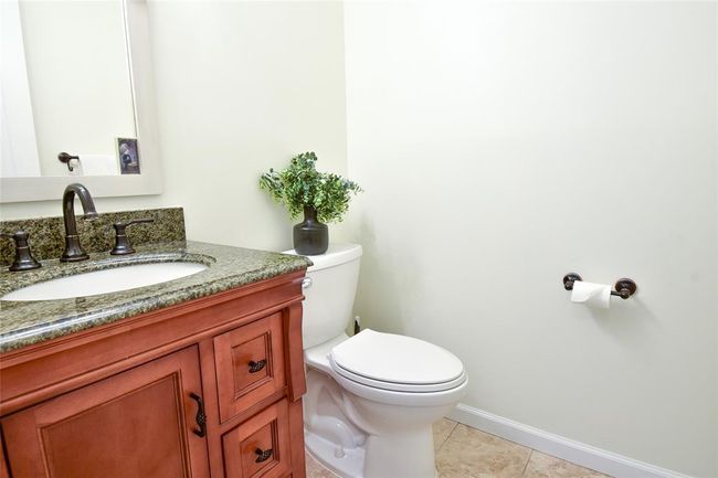 Bathroom featuring toilet, vanity, baseboards, and tile patterned floors | Image 9