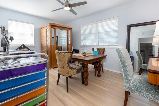 Dining room with ceiling fan and light wood-type flooring | Image 24