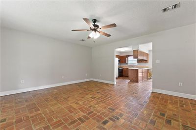 Empty room with sink, ceiling fan, and a textured ceiling | Image 3