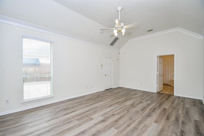 This spacious primary bedroom offers endless possibilities for your ideal layout—whether it’s a cozy reading nook by the window, a seating area, or a king-size bed with room to spare. | Image 17