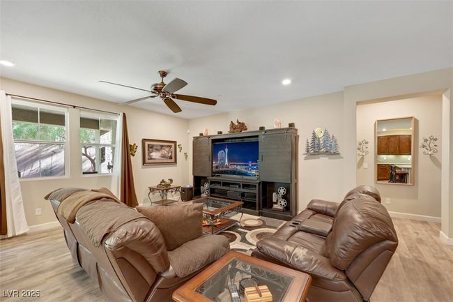 Living area with baseboards, light wood-style flooring, and a ceiling fan | Image 18