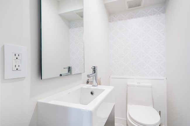 Bathroom featuring visible vents, toilet, and a sink | Image 17