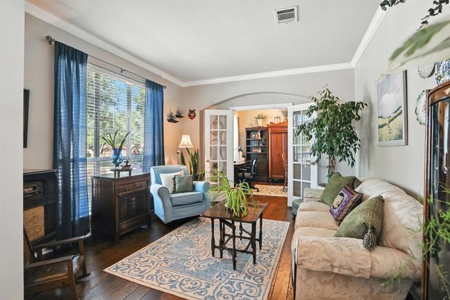 Living area featuring french doors, dark wood finished floors, and ornamental molding | Image 5