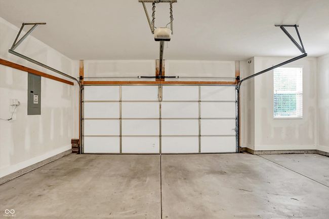 garage featuring electric panel and a garage door opener | Image 19