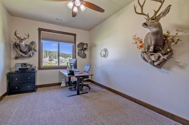 Office area with carpet floors, ceiling fan, and baseboards | Image 35