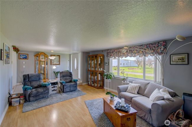 Large well lit living room looking towards the main entry | Image 12