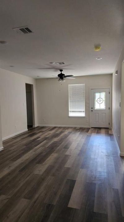 Unfurnished room with ceiling fan and dark hardwood / wood-style flooring | Image 3