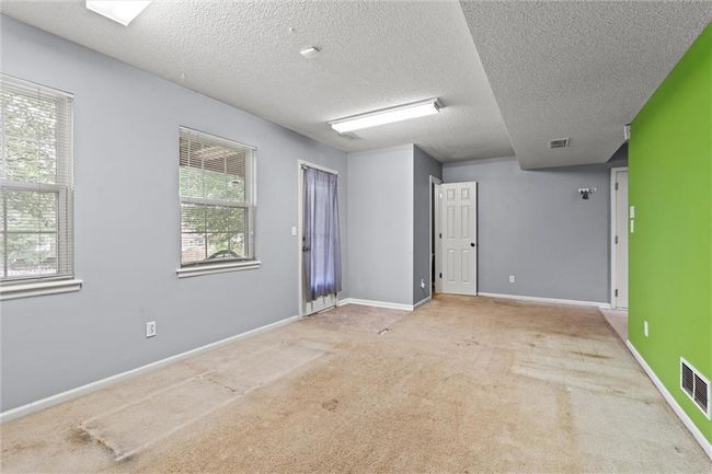 Carpeted empty room featuring a textured ceiling | Image 32
