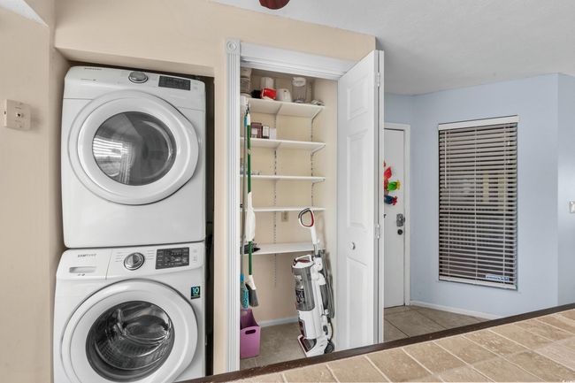 Laundry room featuring full sized stacked washer and dryer | Image 21