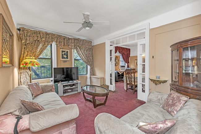 Living room featuring carpet, ceiling fan, and french doors | Image 7