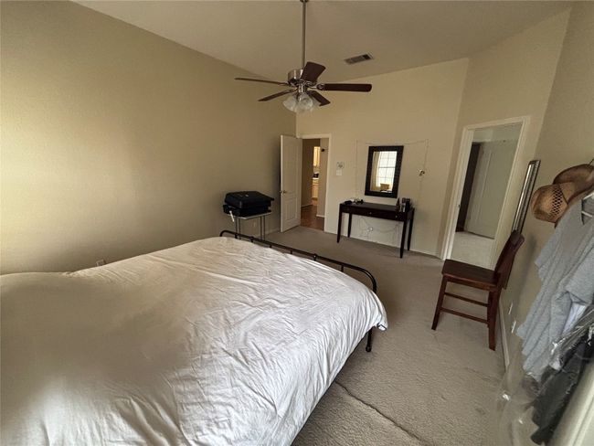 Carpeted bedroom with vaulted ceiling and ceiling fan | Image 15
