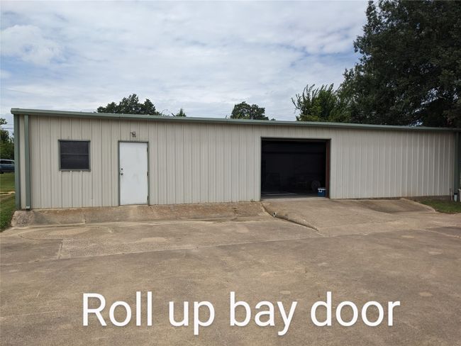 View of outdoor structure featuring concrete driveway | Image 10