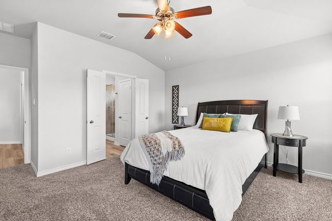 Bedroom featuring lofted ceiling, carpet floors, and ceiling fan | Image 23