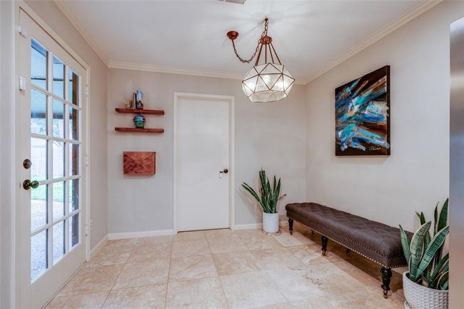 The breakfast nook is open to the kitchen, features a beautiful modern light pendant, tile flooring, crown molding throughout. Door through to Utility room & out to back yard & covered patio. | Image 18