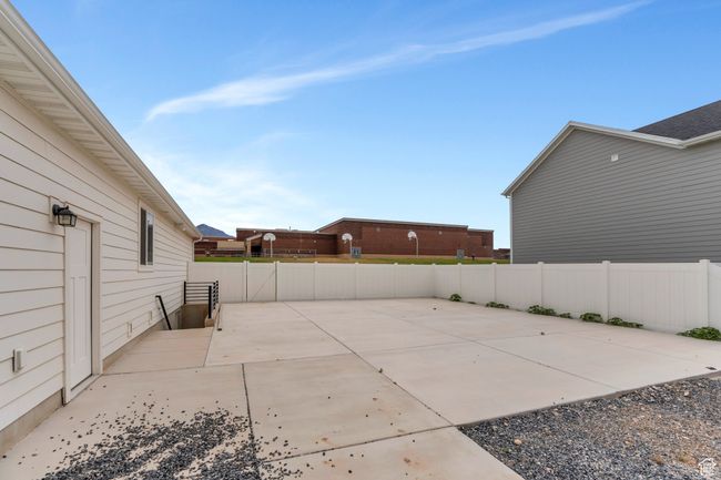 Fenced backyard with a patio | Image 22