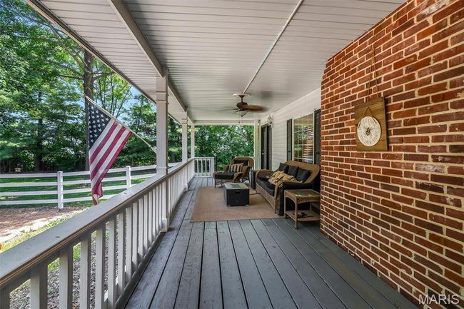 Deck featuring an outdoor hangout area and ceiling fan | Image 7