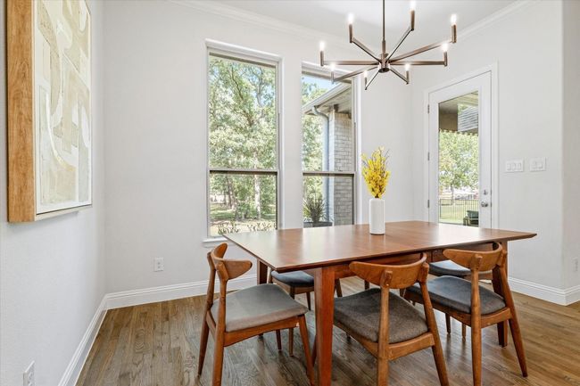 Dining room with a chandelier, crown molding, and wood finished floors | Image 14