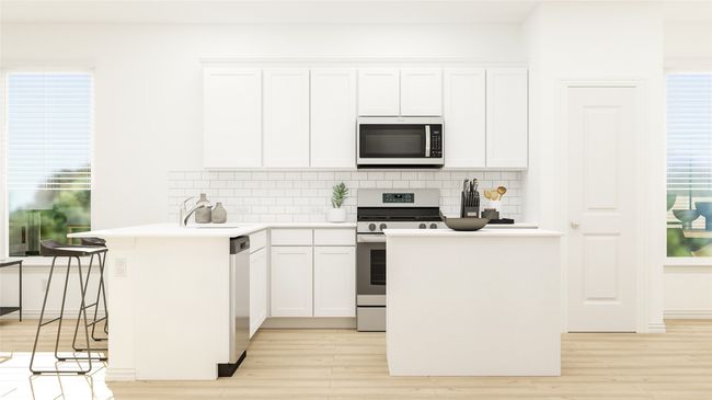 Kitchen featuring appliances with stainless steel finishes, tasteful backsplash, light wood finished floors, and white cabinetry | Image 9