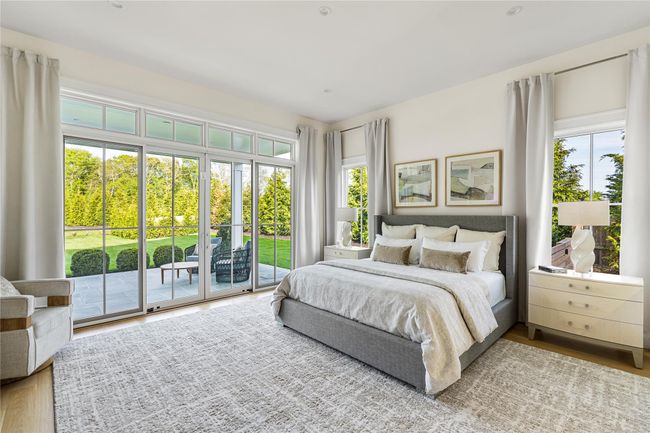 Bedroom with access to outside and wood finished floors | Image 24